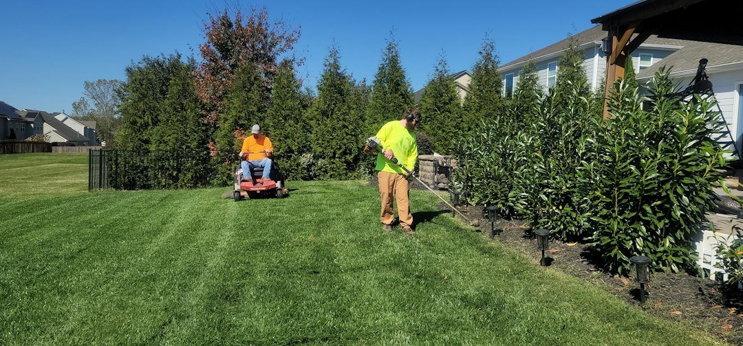 a-man-mowing-a-lawn-with-a-lawn-mower-bsld7gjqwji